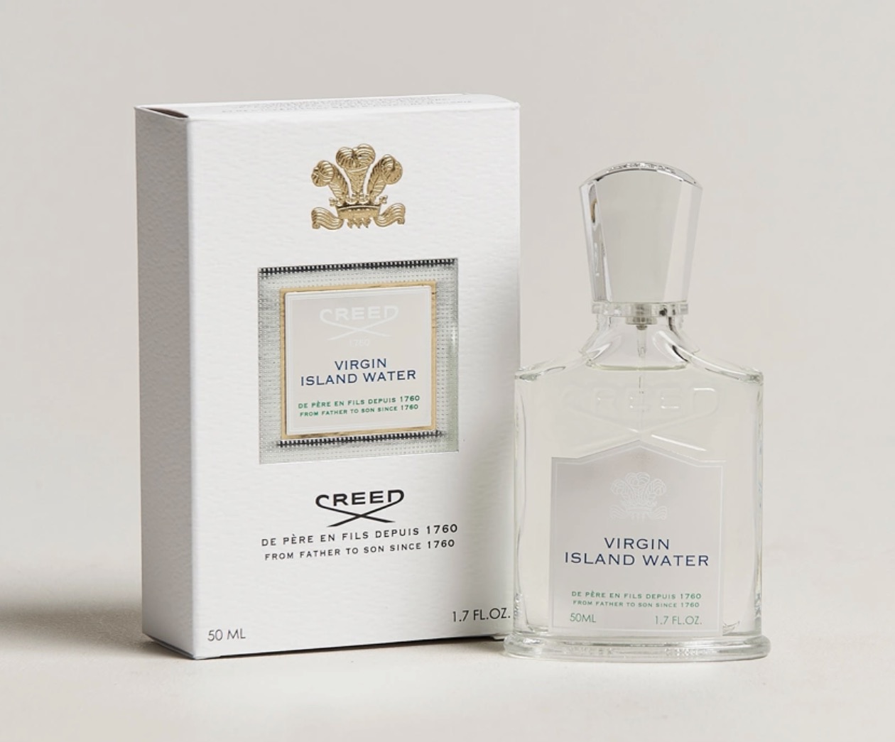 Creed Virgin Island Water bottle beside its box, minimal white packaging