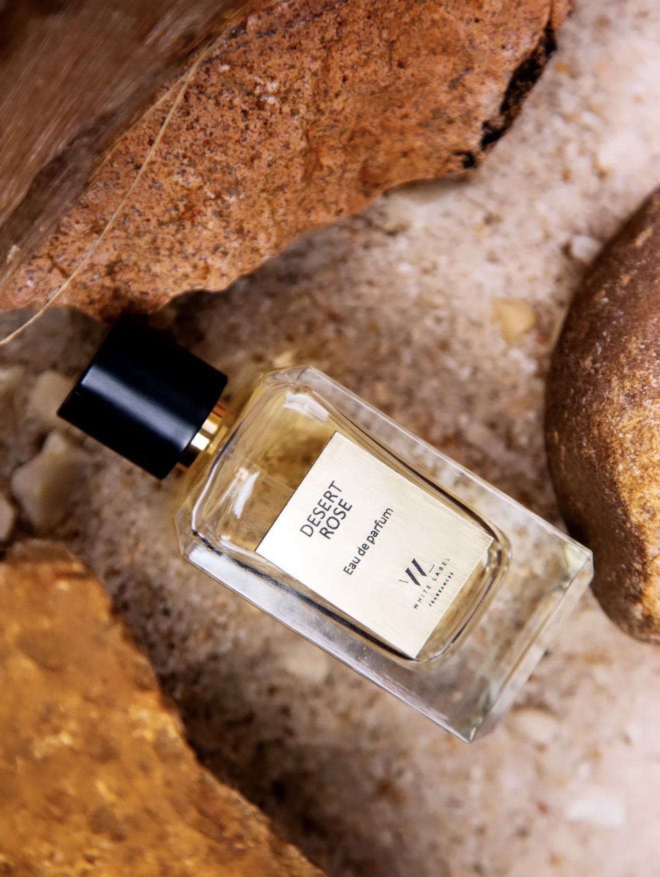 White Label Fragrances Desert Rose perfume bottle on rocks