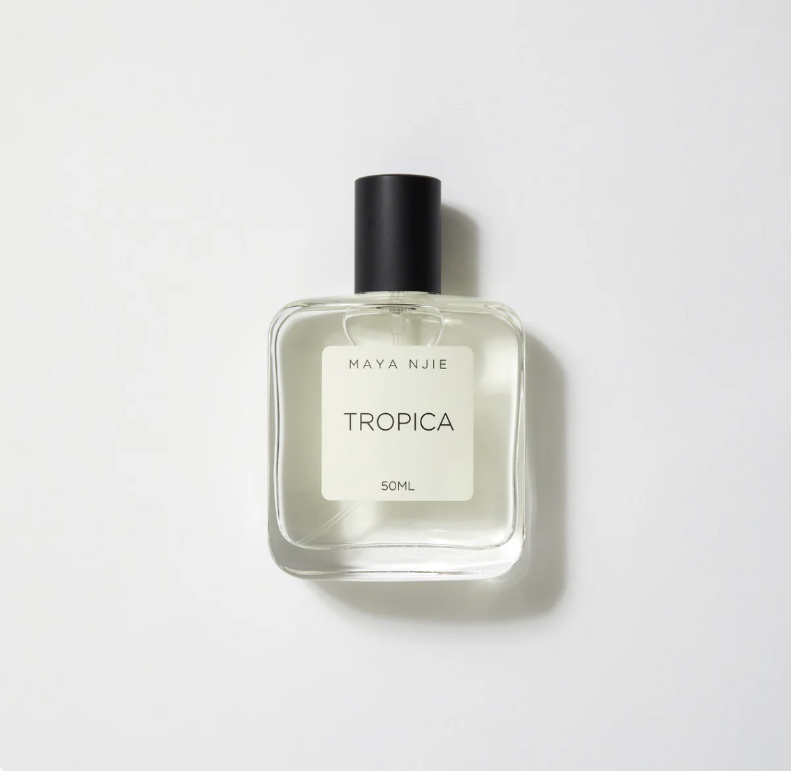 Maya Njie Tropica perfume bottle, clear glass with cream label