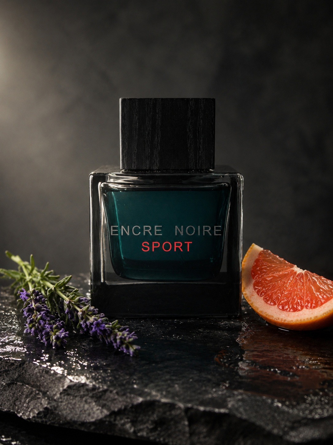 Lalique Encre Noire Sport bottle with lavender and grapefruit slice on wet dark slate