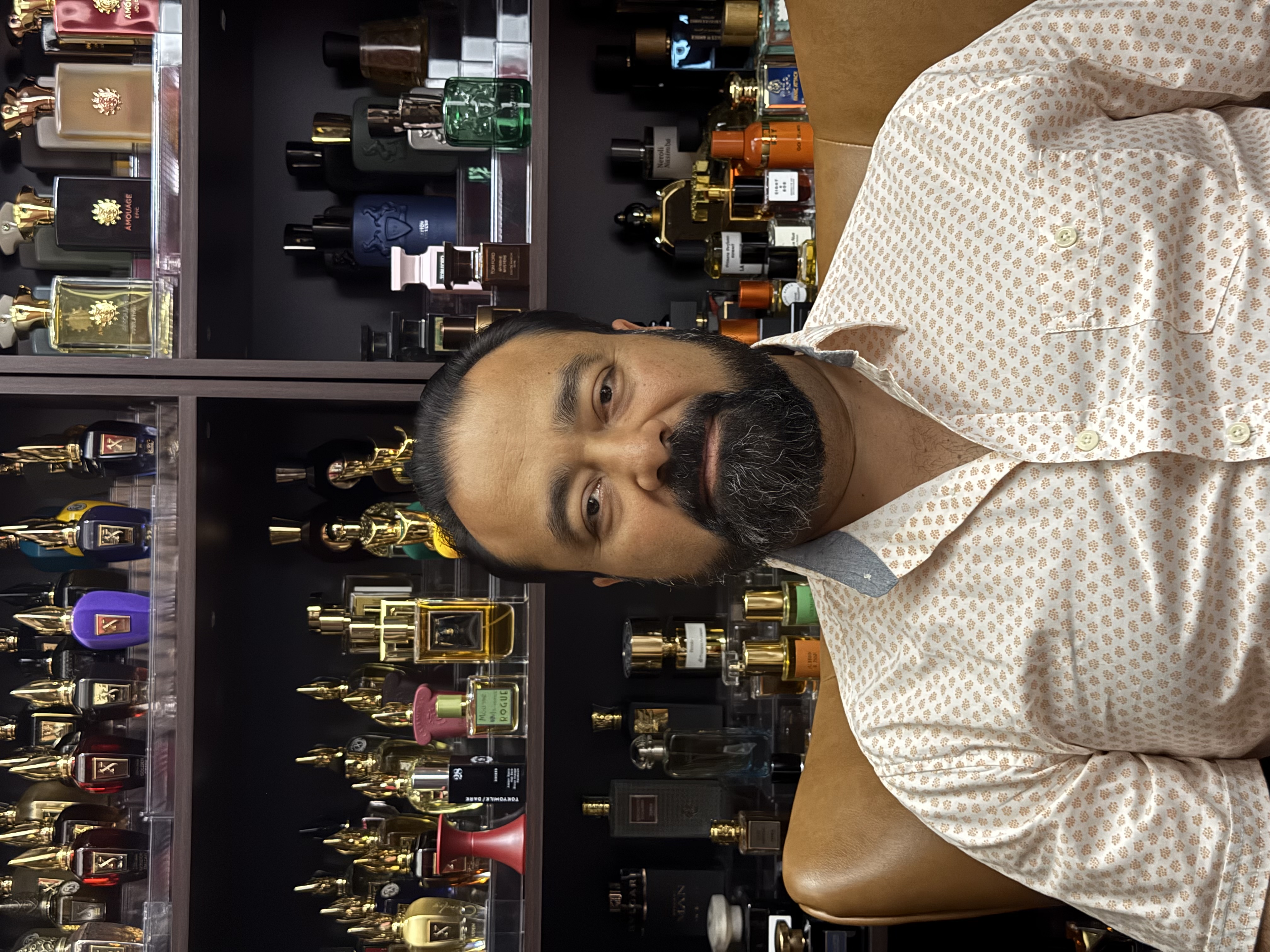 Gautam Kannan in the Society of Scents and Spirits studio, surrounded by the fragrance collection